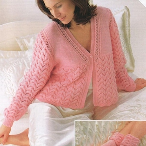 Peut inclure: Un cardigan rose en tricot avec un motif en dentelle et une fermeture à boutons. Le cardigan est porté sur une robe de dessous blanche. L'image comprend le texte "Includes Larger Sizes".