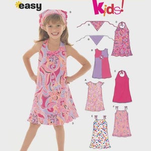Könnte beinhalten: New Look 6478 Schnittmuster für Kinder mit verschiedenen Kleiderstilen und einem Kopftuch. Das Schnittmuster enthält Abbildungen von ärmellosen Kleidern mit Neckholder, Rüschen sowie Blumen- oder Punktemustern in Pink, Lila und Orange.