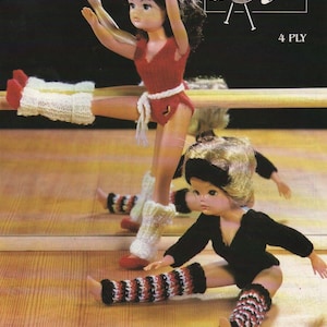 May include: Knitting pattern for doll leg warmers. The pattern shows two dolls wearing leg warmers. One doll is wearing white leg warmers and the other is wearing black and red striped leg warmers. The pattern is for 4 ply yarn.