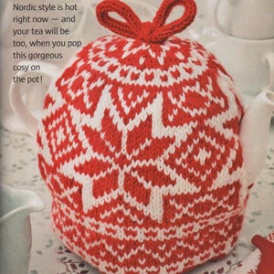 May include: A red and white knitted tea cozy with a Nordic pattern, featuring a bow on top. The text on the image reads, "Nordic style is hot right now - and your tea will be too, when you pop this gorgeous cosy on the pot!"