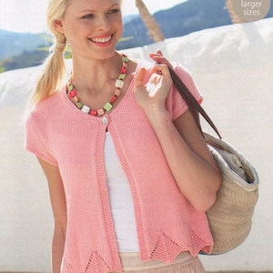 May include: A pale pink, short-sleeved cardigan with a scalloped hem and a single button. The image includes the text "Includes larger sizes". The cardigan is worn with a white top and a light pink skirt. A colourful necklace is also visible.