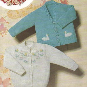 May include: Two knitted baby cardigans. One is white with a floral design and the other is teal blue with two white swan appliques.