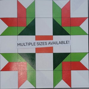 May include: A geometric quilt block design featuring red, green, and white shapes. The design includes star-like patterns and rectangular elements. The text "MULTIPLE SIZES AVAILABLE!" is printed on a white label.