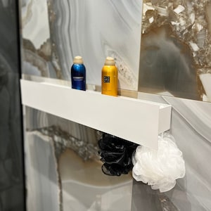 Long shelf with hooks. Modern floating shelf for bathroom. Designer stainless steel wall mounted shelf. Minimalist bathroom shelving.