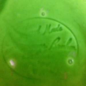 May include: A green ceramic plate with a white oval sticker that says "Hand Made by Robin".