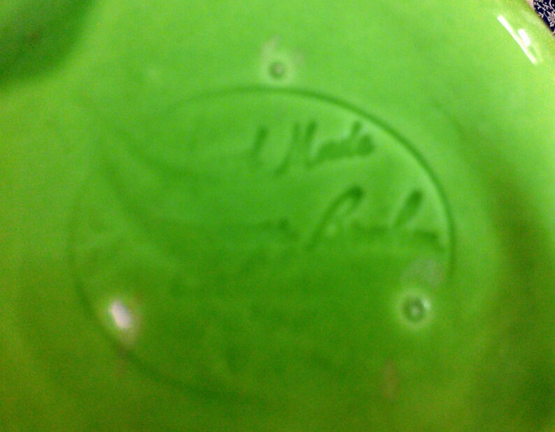 May include: A green ceramic plate with a white oval sticker that says "Hand Made by Robin".
