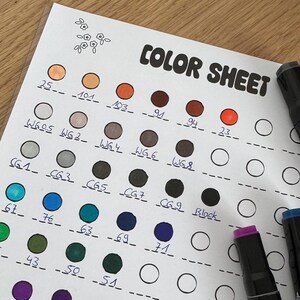 May include: A color sheet with a grid of numbered circles, each filled with a different color. The colors are arranged in rows, with the first row being shades of brown, the second row being shades of gray, the third row being shades of blue, the fourth row being shades of green, and the fifth row being shades of purple. The sheet is labeled "COLOR SHEET" at the top.