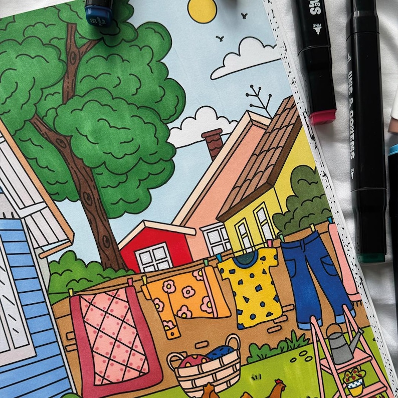 May include: A colorful illustration of a suburban neighborhood with a clothesline hanging between two houses. The clothesline has a variety of colorful clothing items hanging on it, including a yellow shirt with geometric shapes, a blue shirt with a geometric pattern, and a pair of blue jeans. There is a basket of laundry in the foreground, and a small pink ladder.