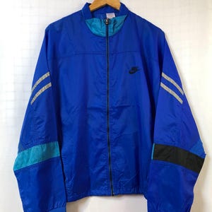 Chaqueta deportiva Nike vintage | Azul y gris | Cortavientos de nailon con cremallera estilo años 90, corte oversize, serie internacional, logo, estilo streetwear, unisex, talla M/L