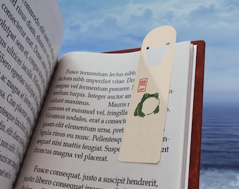 Marcapáginas metálico de rana japonesa, inspirado en Matsumoto Hoji, ilustración minimalista en tinta, regalo literario para amantes de los libros.