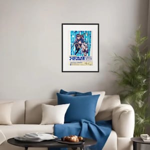 May include: Framed poster with a vibrant anime-style illustration and Japanese text. The artwork shows two characters in dynamic poses against a blue and white backdrop. The poster is mounted on a white wall above a beige sofa with blue cushions.