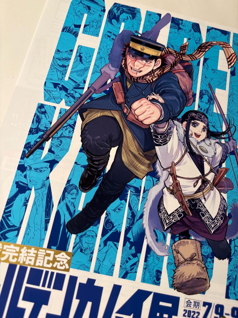 May include: A colourful illustration of two characters in dynamic poses. One, in a military uniform, holds a rifle. The other, in traditional clothing, carries a bow. The background is blue with character portraits and Japanese text.