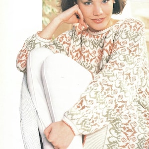 May include: A white, green, and peach patterned sweater with a crew neck and long sleeves.