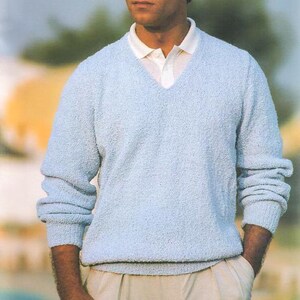 May include: A light blue v-neck sweater with a textured knit.