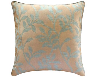 May include: A square throw pillow featuring a light peach or apricot background with a woven, raised leaf pattern in a soft, pale mint green color. The fabric has a subtle sheen and a textured appearance, with the botanical design covering the surface.