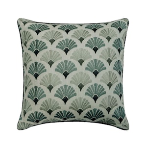 May include: A square throw pillow featuring an off-white base fabric with a repeating pattern of embroidered fan-shaped motifs in shades of sage green, teal, and dark charcoal. The pillow is finished with a thin dark charcoal piping along the edges.