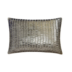 May include: A decorative throw pillow with a silver and gray geometric pattern. The pillow is made of a soft, textured fabric.