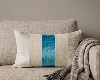 May include: A rectangular throw pillow featuring a central vertical stripe of vibrant teal velvet, flanked by panels of textured beige fabric and outer sections of light cream crushed velvet, creating a multi-textured and layered appearance.