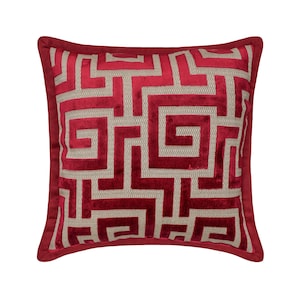 May include: Red and beige throw pillow with a geometric pattern. The pillow has a red border and a beige background with a red geometric pattern.