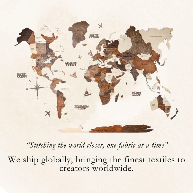 May include: A wooden world map with a light brown background. The map is made up of individual pieces of wood, each representing a different country. The map is surrounded by a white border and the text "Stitching the world closer, one fabric at a time" is printed below the map.