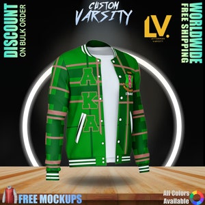 May include: A green varsity jacket with white accents, featuring the letters "AKA" in a bold font. The jacket has a plaid pattern with pink stripes and a patch with text. The image also includes the text "Custom Varsity".