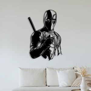 Op de afbeelding: Zwart-witte silhouet van Deadpool, een superheld, met een zwaard op zijn rug, die naar de kijker wijst. De afbeelding is een wanddecoratie.