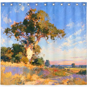 May include: A shower curtain featuring a landscape painting of a large tree standing on a grassy hill under a bright blue sky with scattered white clouds. The scene includes golden yellow fields, green foliage, and a soft pink horizon at sunset.