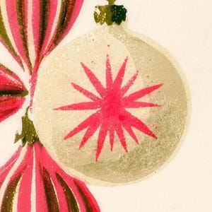 Close-up of the printed design on the beach towel: a cream glass bauble with a pink starburst beside pink and olive striped ornaments, with a speckled screen-print texture.