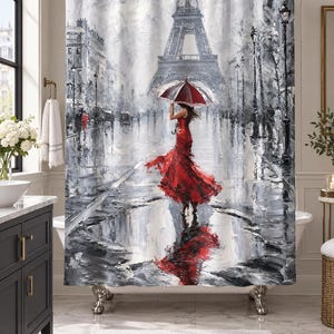 May include: A shower curtain featuring a black and white impressionist painting of the Eiffel Tower in Paris. A figure in a vibrant red dress holds a matching red and white umbrella while standing in a rain-slicked street with a large puddle.
