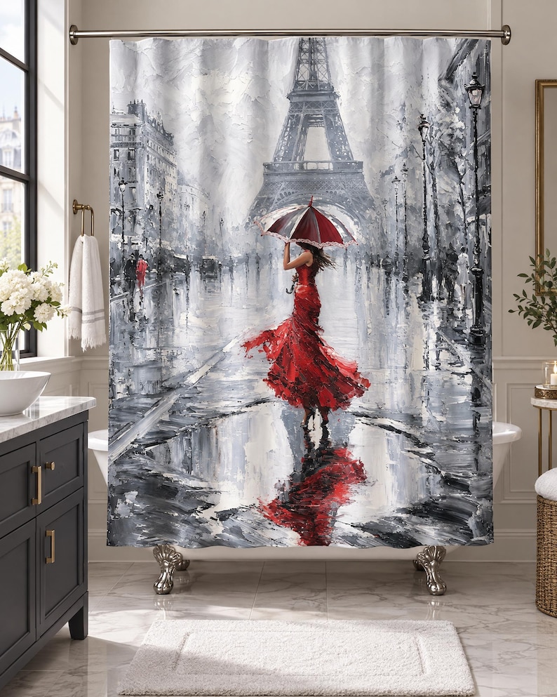 May include: A shower curtain featuring a black and white impressionist painting of the Eiffel Tower in Paris. A figure in a vibrant red dress holds a matching red and white umbrella while standing in a rain-slicked street with a large puddle.