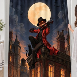 Pumpkin violinist full moon shower curtain over a bathtub in a white-tiled bathroom: a pumpkin-headed figure in a top hat and red coat plays violin on a brick rooftop beside a black cat; a woman's hand pulls back the right edge.