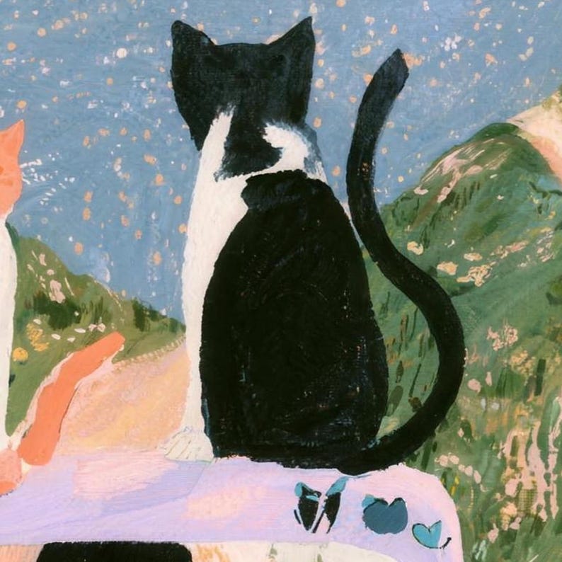 Close-up of the printed design on the beach towel: the black and white cat seen from behind with its tail curled, sitting on the lavender car above the top of the driver's dark hair.