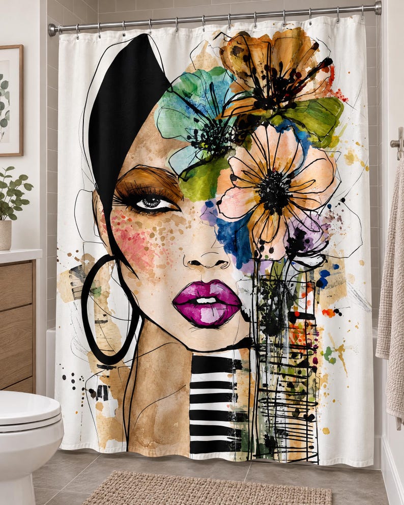 May include: A white shower curtain featuring a large, artistic illustration of a person's face with vibrant watercolor flowers in shades of orange, green, and blue, bright pink lips, a black hoop earring, and black and white striped accents.