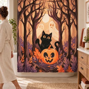 Wider view of a bright bathroom with the black cat and jack-o'-lantern shower curtain closed across the tub, a wooden vanity to the right and a woman in a robe and slippers walking past.