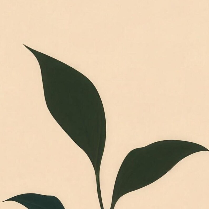 Close-up of the printed design on the beach towel: the dark green leaves of the seedling against a plain cream background.