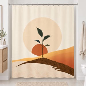 Straight-on view of the whole boho seedling sun shower curtain hanging in a white bathroom, showing the pale sun circle, terracotta half sun, green sprout, brown soil ridge and layered ochre and rust hills.