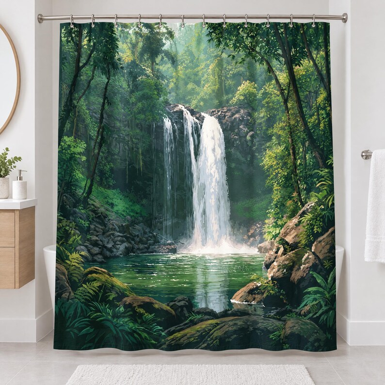 Straight-on view of the whole rainforest waterfall shower curtain hanging in a white bathroom, showing the leafy canopy, the waterfall, the green pool and mossy rocks and ferns along the bottom.