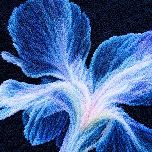 May include: A tufted textile piece featuring a large, stylised floral motif in shades of deep navy, royal blue, light blue, and white. The design is created with dense, textured yarn loops set against a solid, dark navy blue background.
