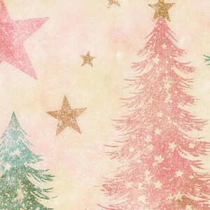 Close-up of the bath mat's print: a pink tree with a gold star on top, a sage tree and pink and gold stars on a vintage-textured cream and pink background.