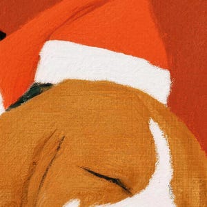 Close-up of the beach towel's painted art: the beagle's closed eye and tan-and-white face under a red-and-white Santa hat on a red background.