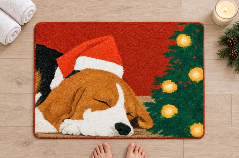 Sleeping beagle Santa hat bath mat seen from above on a light wood floor, with rolled white towels, a candle, pine sprigs and bare feet at the bottom edge.