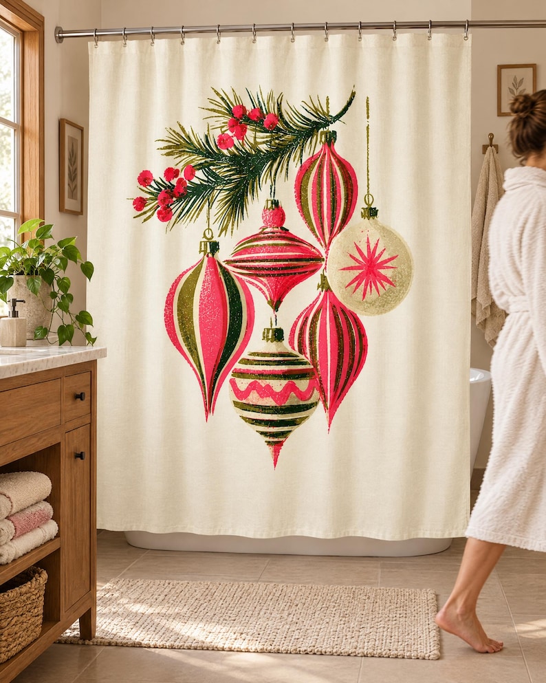 Wider view of a sunny bathroom with the vintage ornament shower curtain closed across the tub, a wooden vanity and plant to the left and a woman in a white robe walking past barefoot.