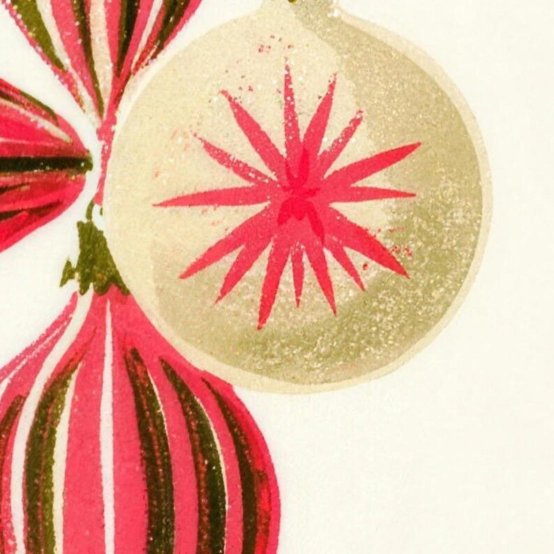 Close-up of the printed design on the shower curtain: a cream glass bauble with a pink starburst next to pink and olive striped ornaments, with a speckled screen-print texture.