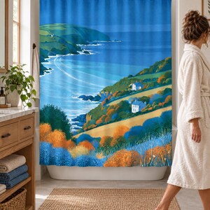 Wider view of a bright bathroom with the retro sea cliff shower curtain closed across the tub, a wooden vanity with folded towels and a plant to the left and a woman in a white robe walking past barefoot.