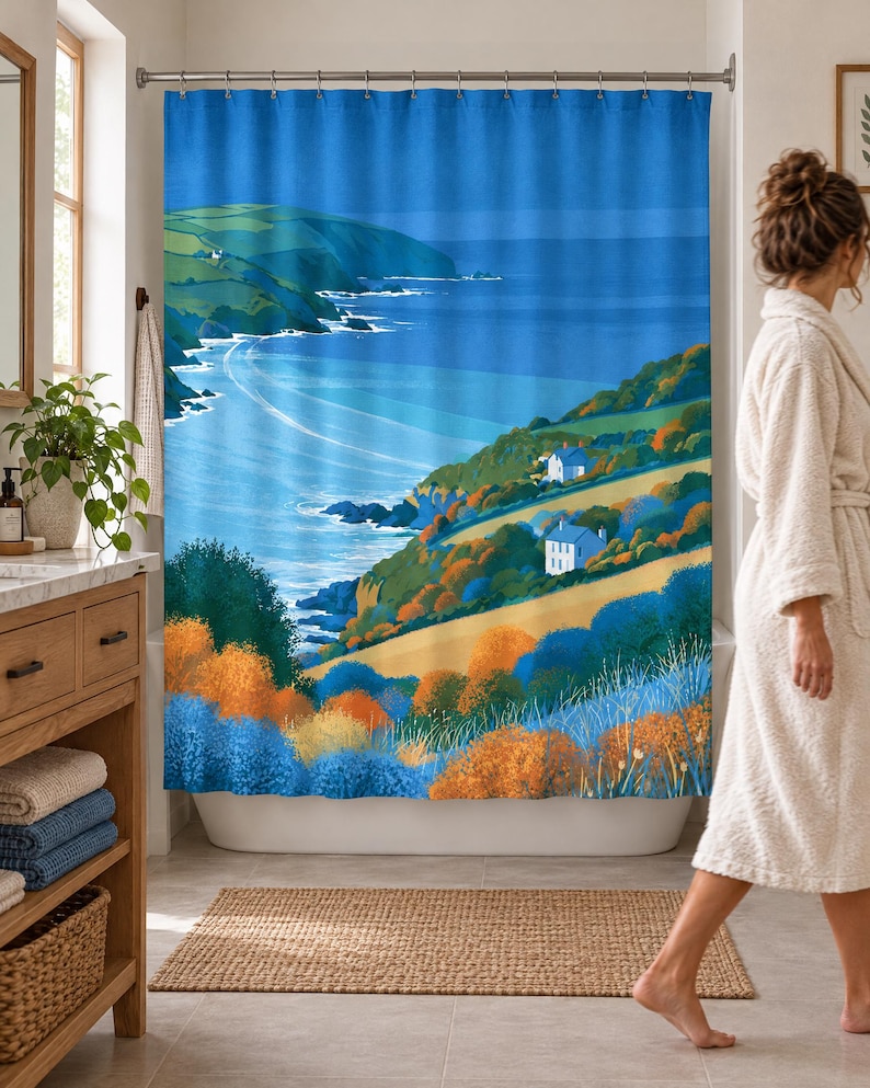 Wider view of a bright bathroom with the retro sea cliff shower curtain closed across the tub, a wooden vanity with folded towels and a plant to the left and a woman in a white robe walking past barefoot.