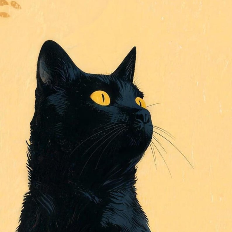 Close-up of the printed design on the beach towel: a black cat's head with gold eyes and long whiskers, looking up against a pale yellow sky.