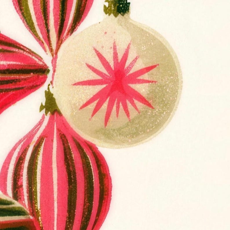 Close-up of the printed design on the bath mat: a cream bauble with a pink starburst between pink and olive striped ornaments, with a speckled screen-print texture.