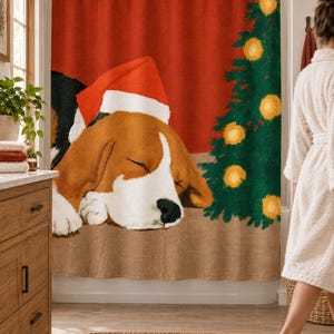Sleeping beagle Santa hat shower curtain in a bright bathroom with a wood vanity and woven rug, as a woman in a white robe walks past.