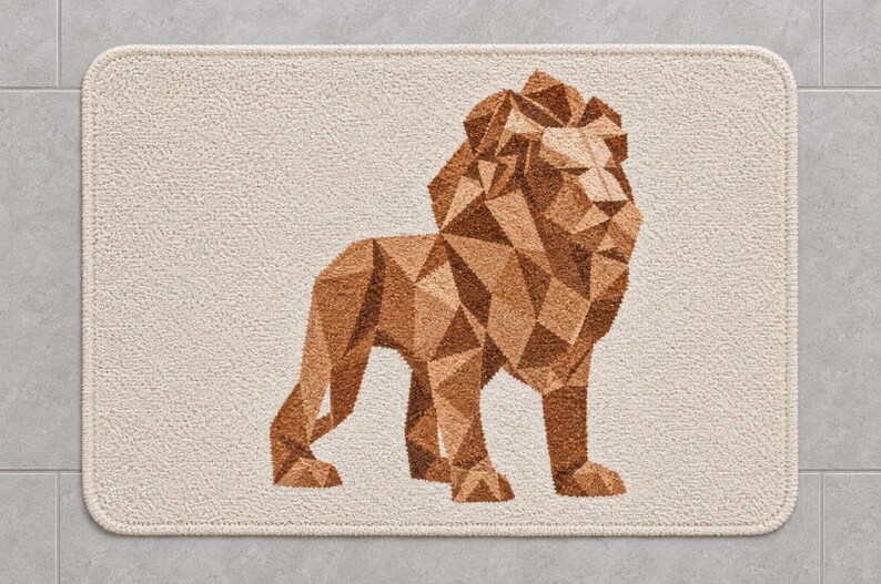 May include: A rectangular bath mat with a cream-coloured textured surface featuring a geometric lion illustration in shades of brown. The lion is composed of various triangular shapes, creating a faceted appearance against the light background.