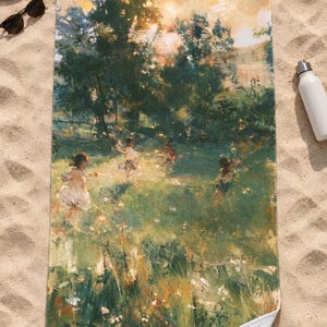 Top-down view of the whole impressionist garden beach towel laid flat on sand, showing the children in the meadow and the tall grass below, with a straw hat, sunglasses and a white water bottle; one corner folds back.